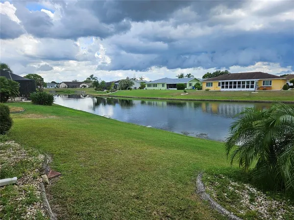 a view of a lake with houses in the back