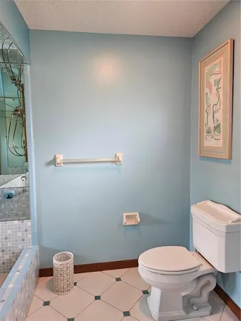a bathroom with a toilet and a shower