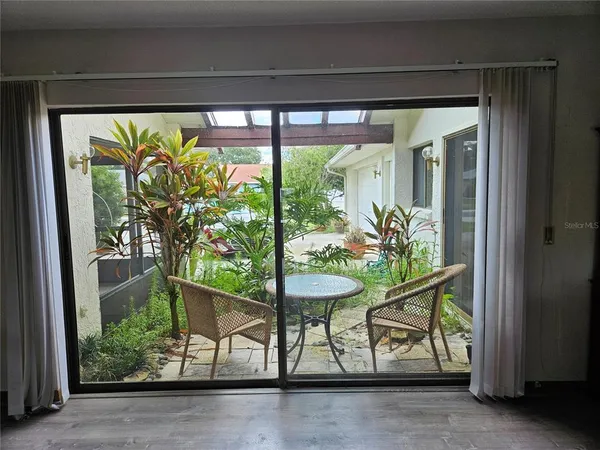a couple of potted plants sitting in front of a window