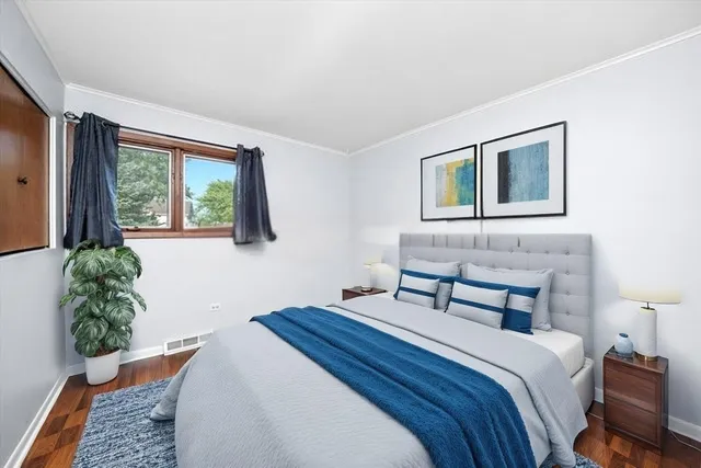 a bedroom with a bed and a potted plant