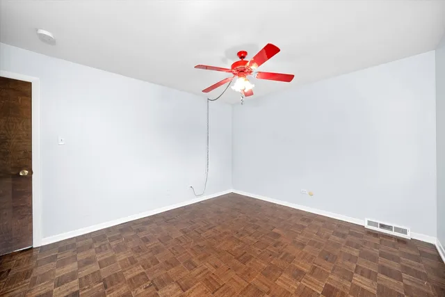 a room with ceiling fan and window