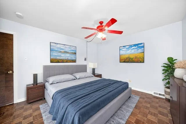 a bedroom with a bed and a chandelier