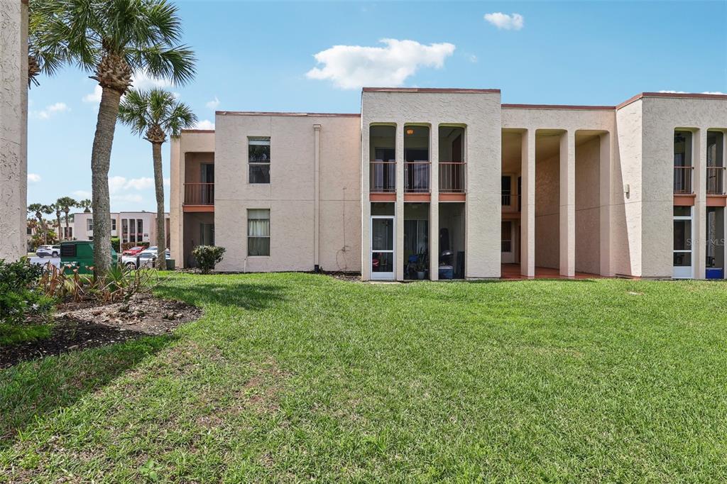 a view of a house with backyard and porch