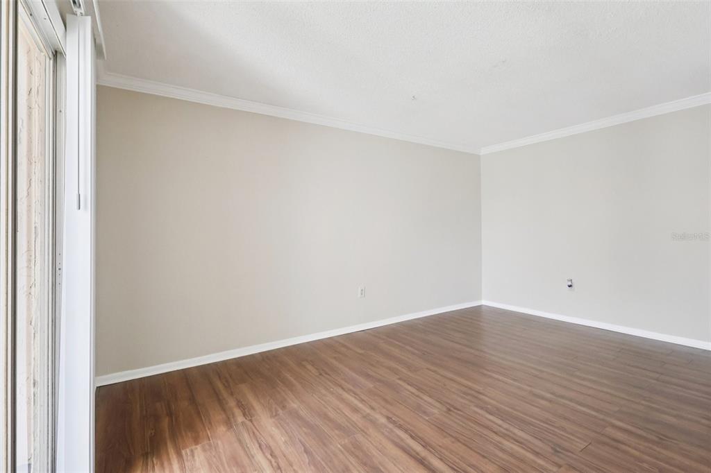 534 Orange Drive, Unit 27 Altamonte Springs, FL 32701 - Photo 11 of 24 a view of an empty room with wooden floor