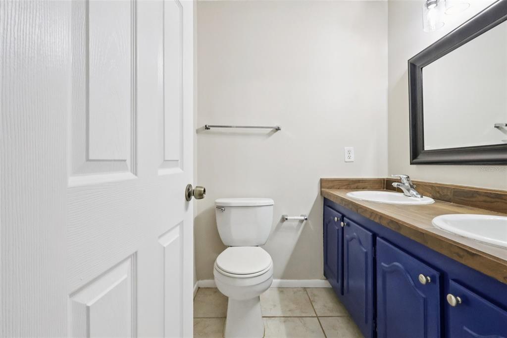 534 Orange Drive, Unit 27 Altamonte Springs, FL 32701 - Photo 13 of 24 a bathroom with a granite countertop toilet sink and mirror