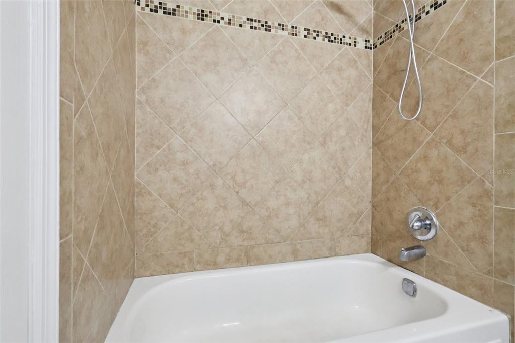 534 Orange Drive, Unit 27 Altamonte Springs, FL 32701 - Photo 14 of 24 a bathroom with a white bath tub and a shower