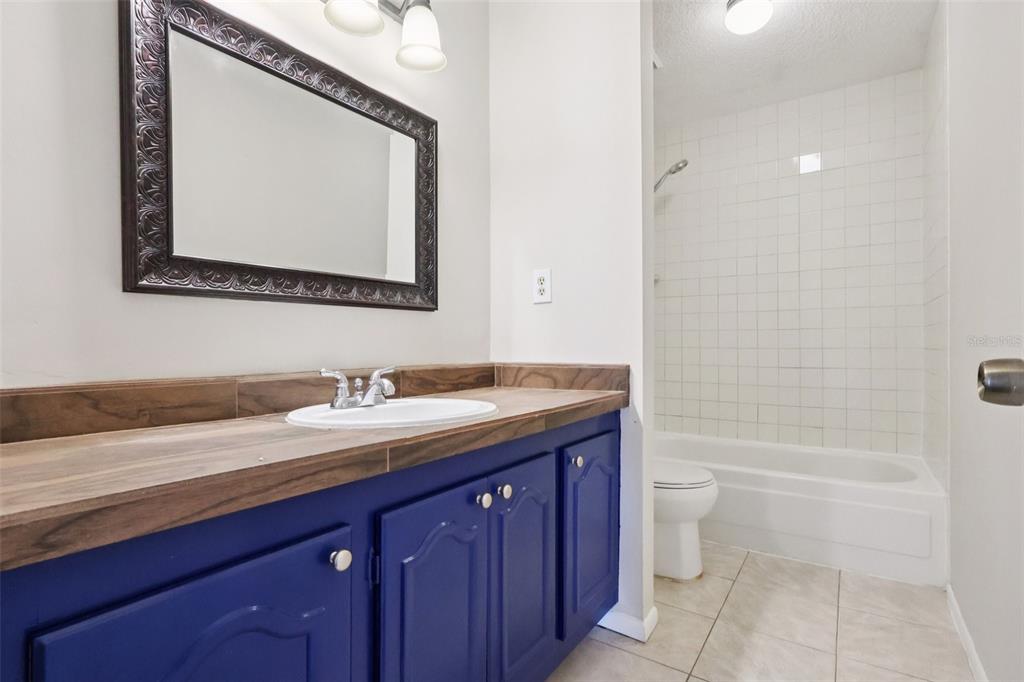 534 Orange Drive, Unit 27 Altamonte Springs, FL 32701 - Photo 16 of 24 a bathroom with a granite countertop sink a toilet and a bathtub
