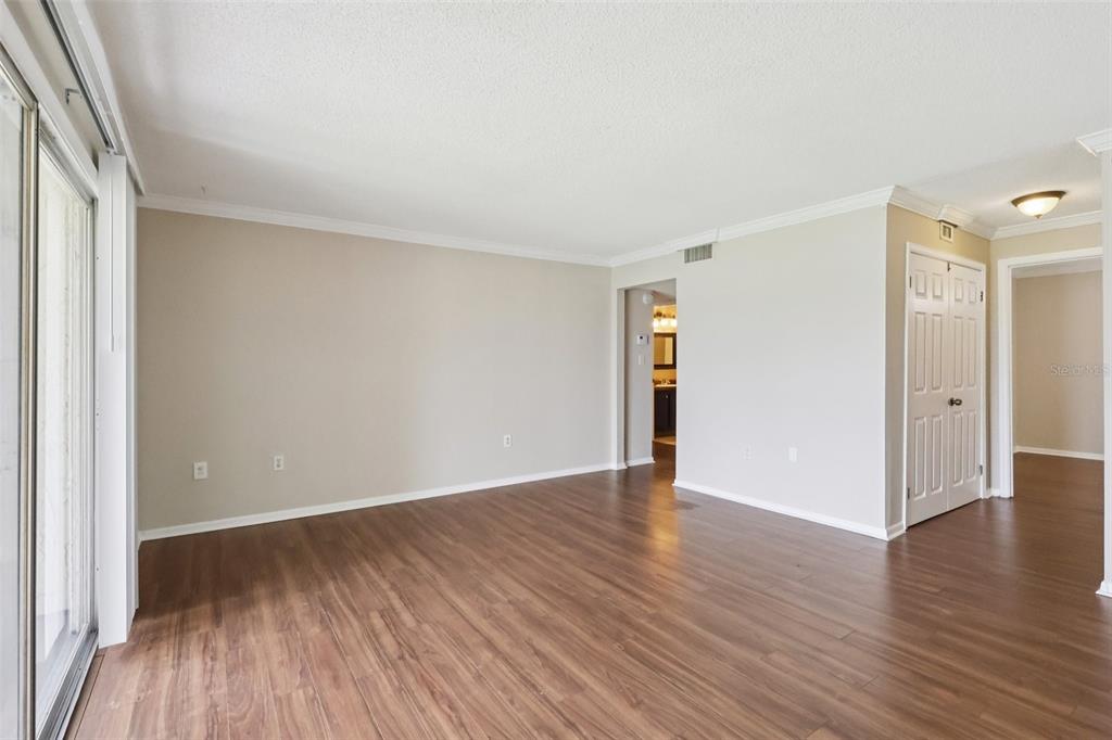 534 Orange Drive, Unit 27 Altamonte Springs, FL 32701 - Photo 5 of 24 a view of an empty room with wooden floor and a window