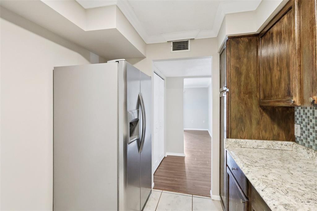 534 Orange Drive, Unit 27 Altamonte Springs, FL 32701 - Photo 8 of 24 a kitchen with stainless steel appliances granite countertop a refrigerator and a sink