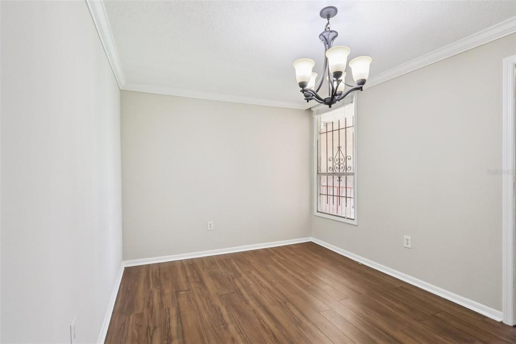 534 Orange Drive, Unit 27 Altamonte Springs, FL 32701 - Photo 9 of 24 a view of empty room with wooden floor and fan