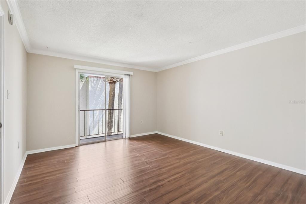 534 Orange Drive, Unit 27 Altamonte Springs, FL 32701 - Photo 10 of 24 a view of empty room with wooden floor and fan