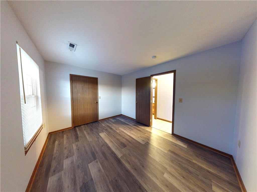 502 Brookstone Court Butler, PA 16001 - Photo 13 of 14 a view of an empty room with wooden floor and window