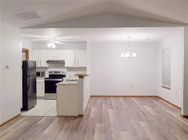 a kitchen with a refrigerator and a stove top oven