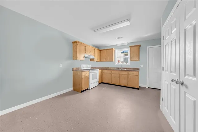 a view of a kitchen with a sink cabinets and a window