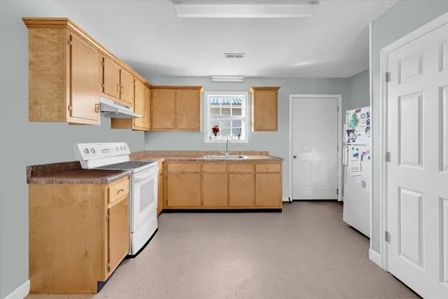 a utility room with cabinets washer and dryer