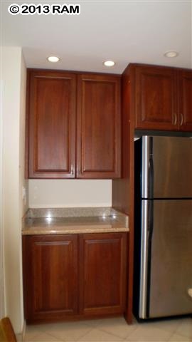 3833 Lower Honoapiilani Road, Unit A203 Lahaina, HI 96761 - Photo 17 of 26 a view of a kitchen with refrigerator and cabinet