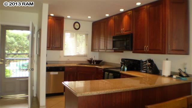 3833 Lower Honoapiilani Road, Unit A203 Lahaina, HI 96761 - Photo 19 of 26 a kitchen that has a sink and a stove in it