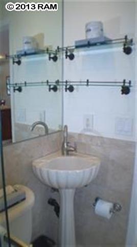 3833 Lower Honoapiilani Road, Unit A203 Lahaina, HI 96761 - Photo 22 of 26 a bathroom with a sink and a mirror