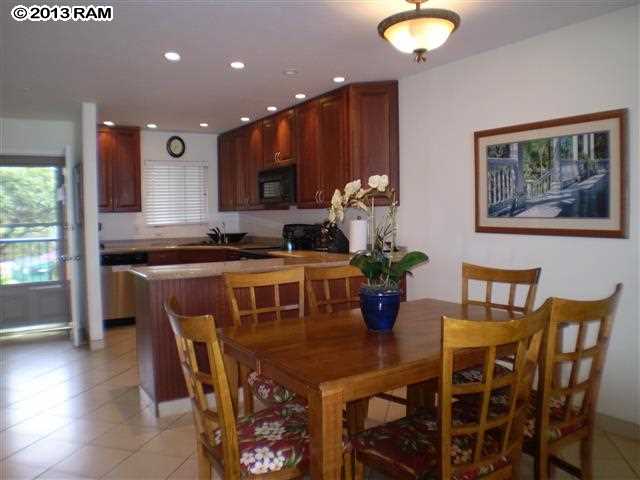 3833 Lower Honoapiilani Road, Unit A203 Lahaina, HI 96761 - Photo 8 of 26 a view of a dining room with furniture and wooden floor