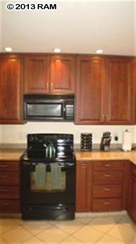 3833 Lower Honoapiilani Road, Unit A203 Lahaina, HI 96761 - Photo 9 of 26 a kitchen with granite countertop a stove and a sink