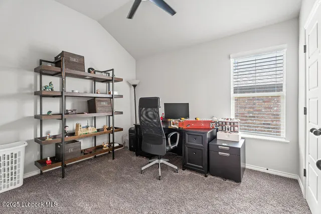 an empty room with a ceiling fan and window