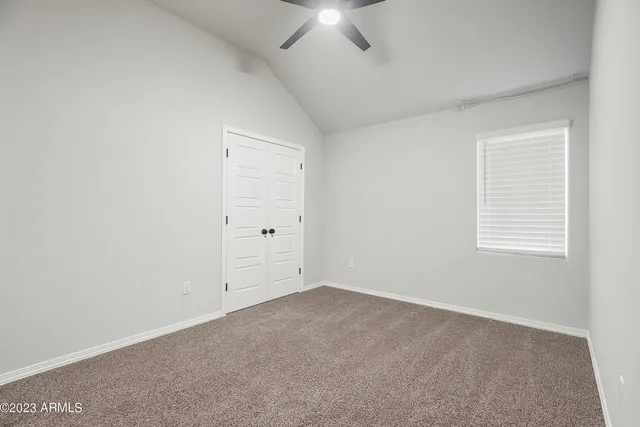 a bed room with a bed window and a chair