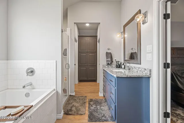 a view of a hallway with closet and wooden floor