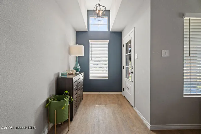 a view of hallway with furniture and a window