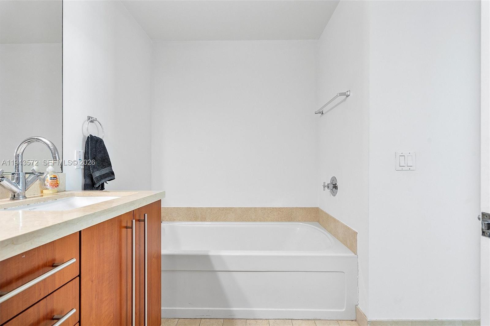 79 Southwest 12th Street, Unit 3809S Miami, FL 33130 - Photo 12 of 21 a bathroom with a sink and mirror