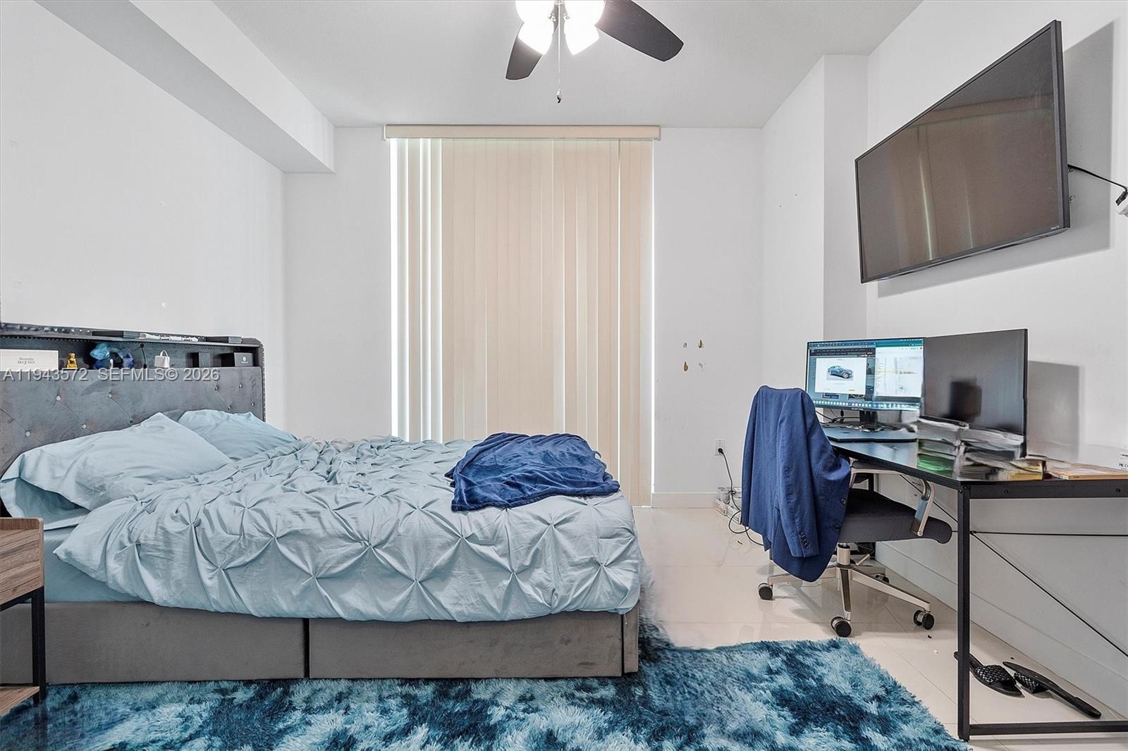 79 Southwest 12th Street, Unit 3809S Miami, FL 33130 - Photo 13 of 21 a bedroom with a bed and a flat screen tv