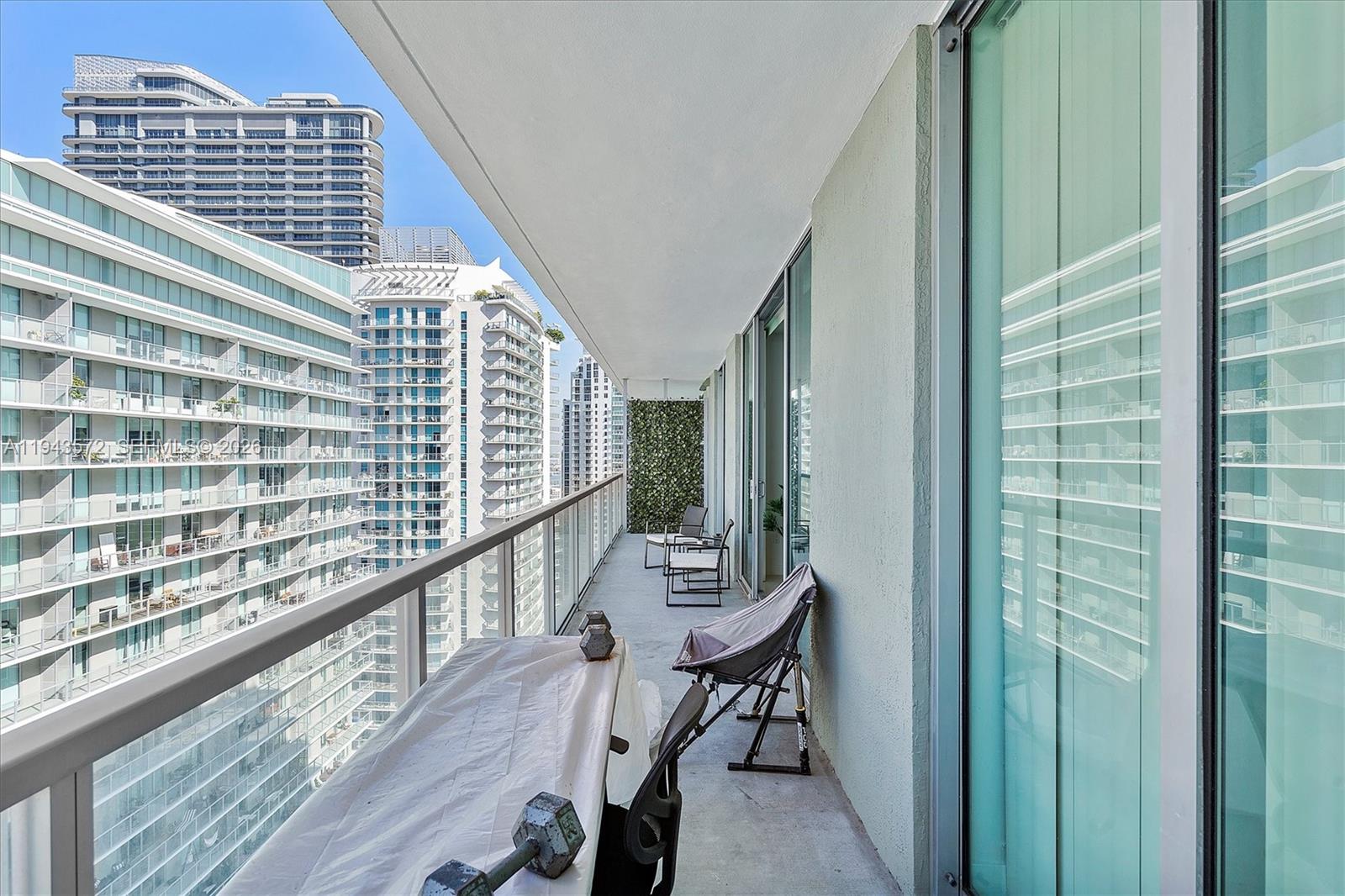 79 Southwest 12th Street, Unit 3809S Miami, FL 33130 - Photo 16 of 21 a view of a balcony with chairs