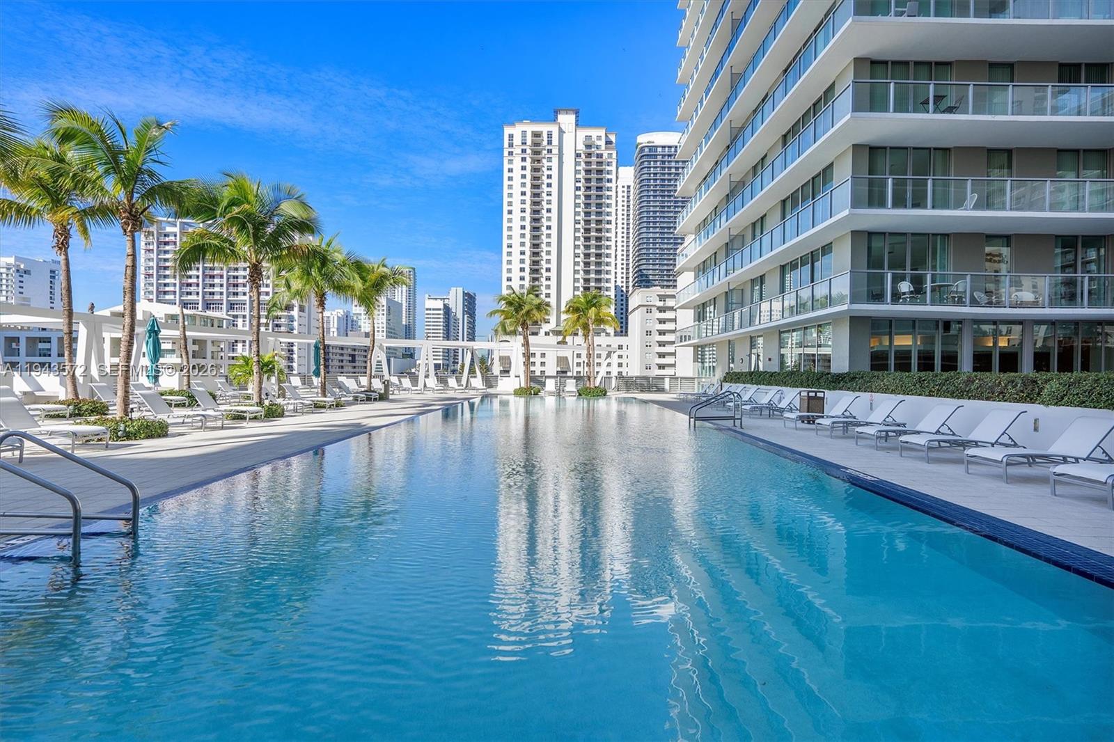 79 Southwest 12th Street, Unit 3809S Miami, FL 33130 - Photo 3 of 21 a swimming pool with outdoor seating and yard