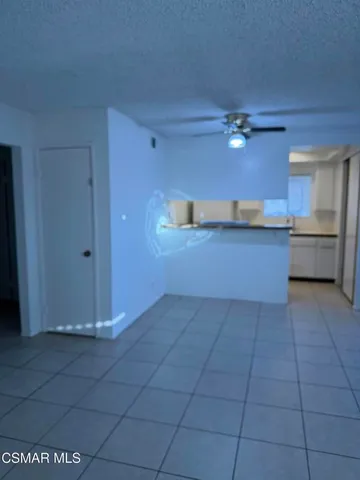a kitchen with kitchen island granite countertop a stove a sink and a refrigerator