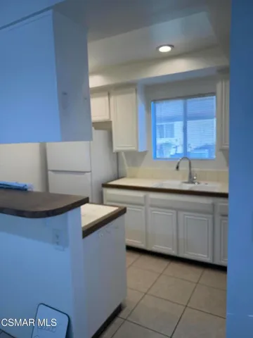 a kitchen with stainless steel appliances granite countertop a sink and a stove