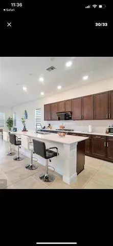 a kitchen with kitchen island sink stove and cabinets