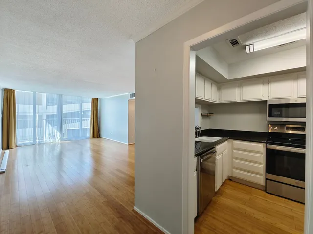 a kitchen with granite countertop a sink and stainless steel appliances