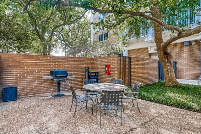 a view of a chairs and table in backyard of the house