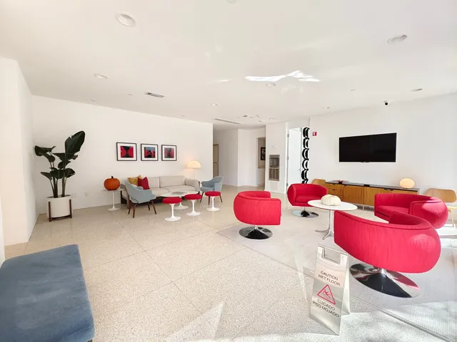 a living room with furniture and floor to ceiling window