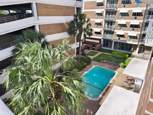 a view of empty room with wooden floor and ceiling fan