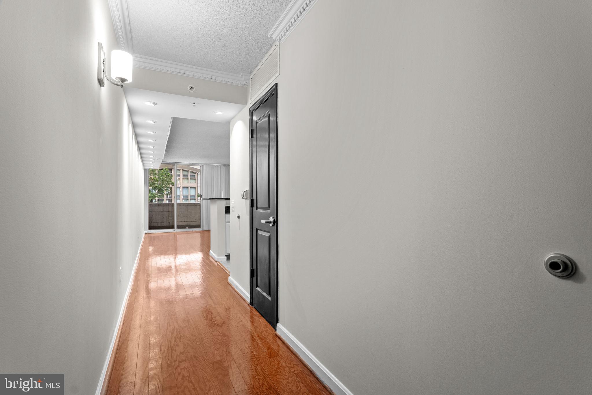 880 North Pollard Street, Unit 224 Arlington, VA 22203 - Photo 2 of 39 a view of a hallway with wooden floor