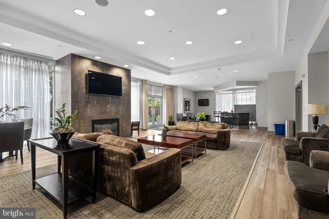 a living room with fireplace furniture and a flat screen tv