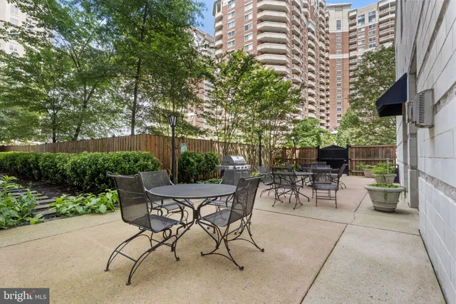 a view of a patio with a table and chairs and potted plants