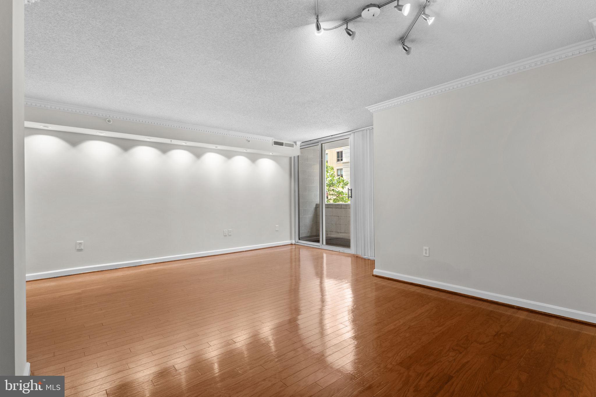 880 North Pollard Street, Unit 224 Arlington, VA 22203 - Photo 10 of 39 a view of an empty room with wooden floor and a window