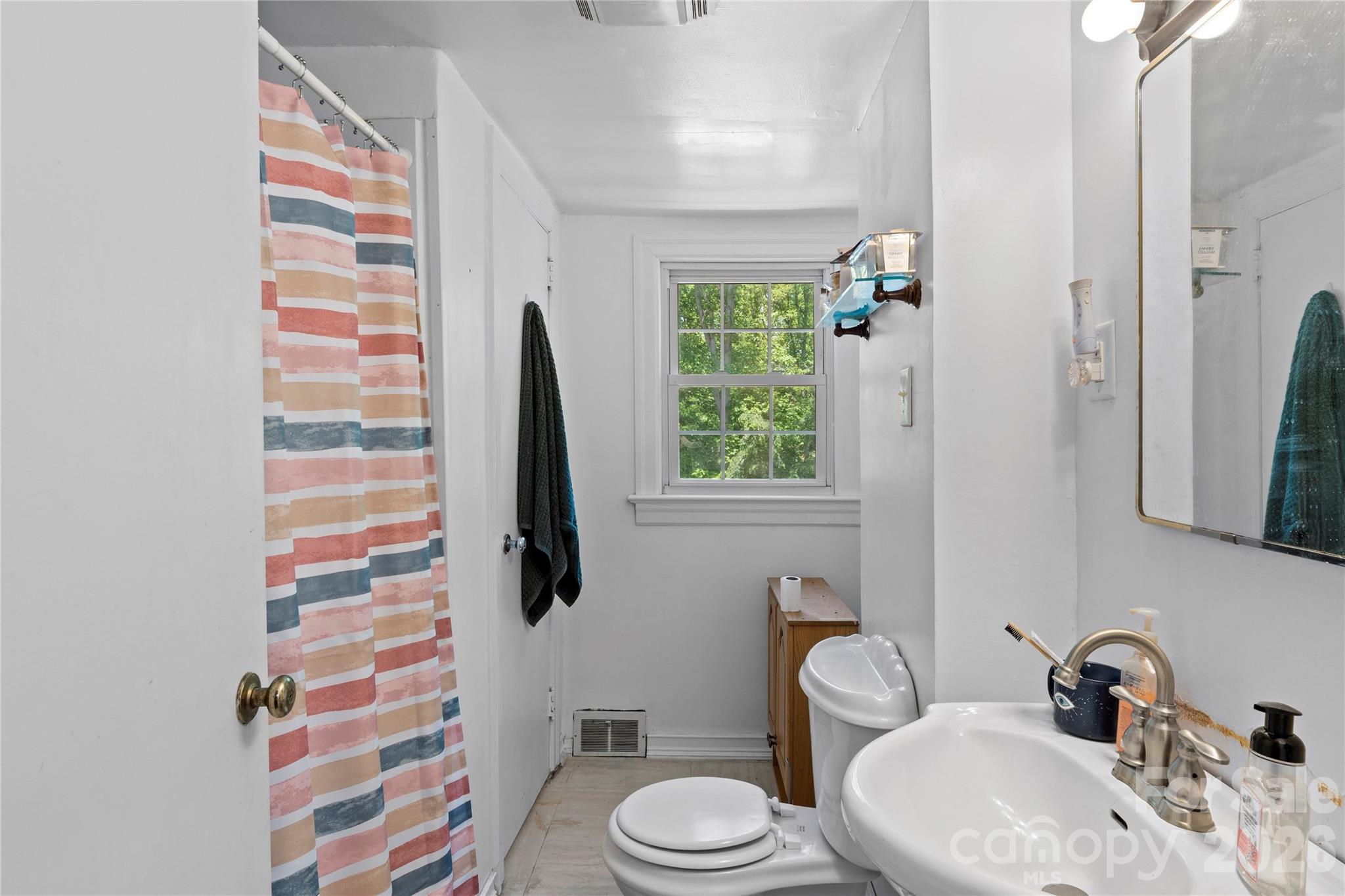 951 Dodson Mill Road Pilot Mountain, NC 27041 - Photo 30 of 48 a bathroom with a sink toilet and shower