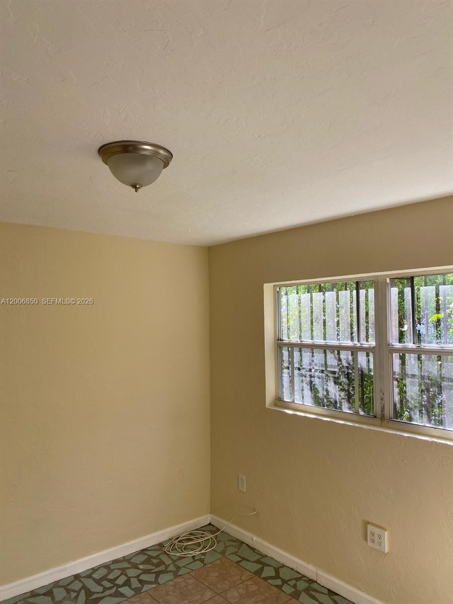 1319 Northwest 60th Street, Unit 5 Miami, FL 33142 - Photo 2 of 10 a view of a room with a large window