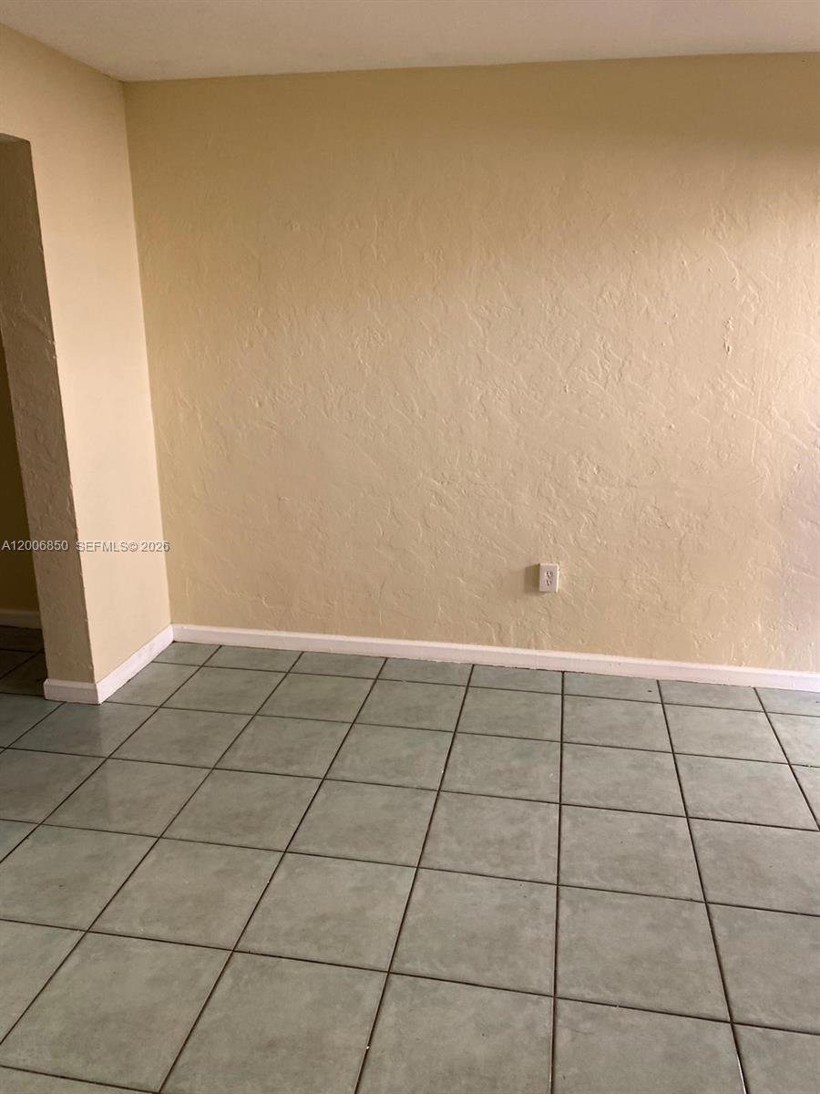 1319 Northwest 60th Street, Unit 5 Miami, FL 33142 - Photo 8 of 10 a view of an empty room and window
