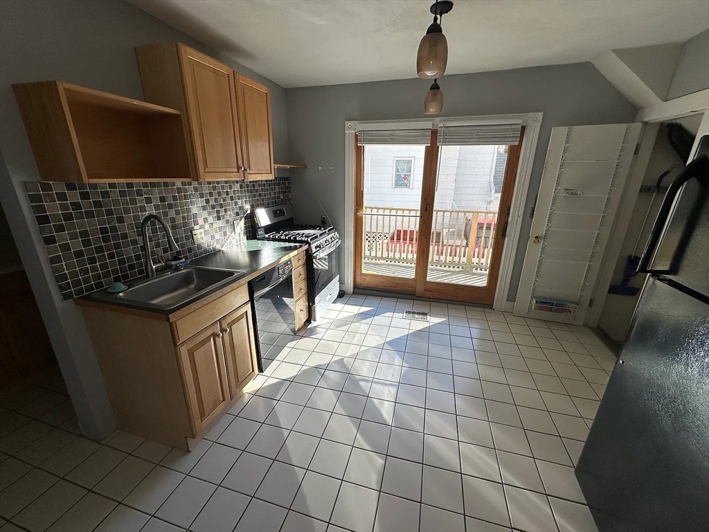 1 Webster Court Stoneham, MA 02180 - Photo 3 of 9 a kitchen with stainless steel appliances a sink stove and cabinets