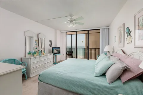 a bedroom with a large bed and a large window