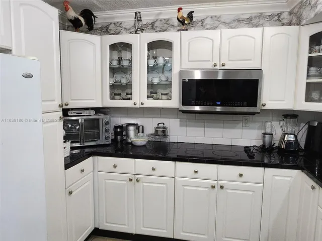 a view of hallway with a glass door shower