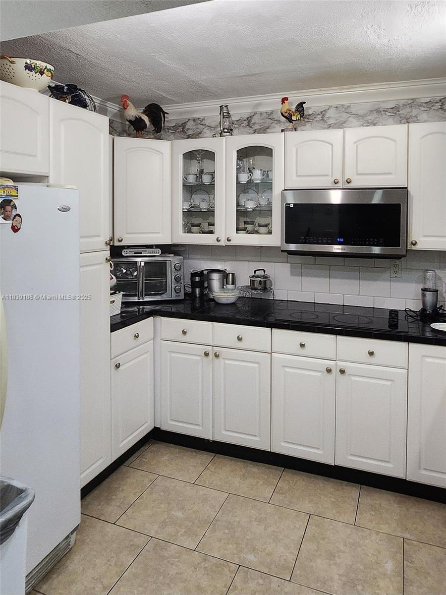 2750 Northeast 183rd Street, Unit 1701 Aventura, FL 33160 - Photo 12 of 40 a kitchen with stainless steel appliances granite countertop white cabinets and sink